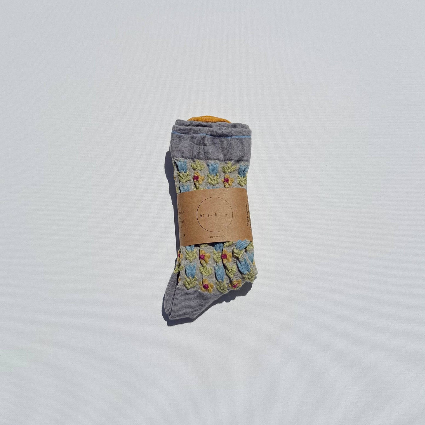 Pair of gray socks with floral patterns on a white background