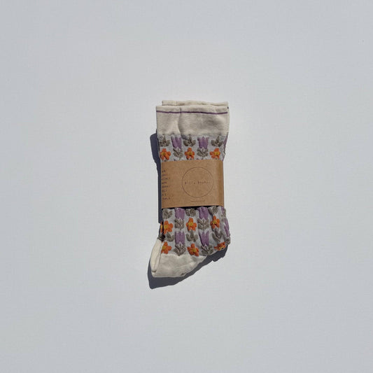 Pair of socks with a floral pattern on a light gray background