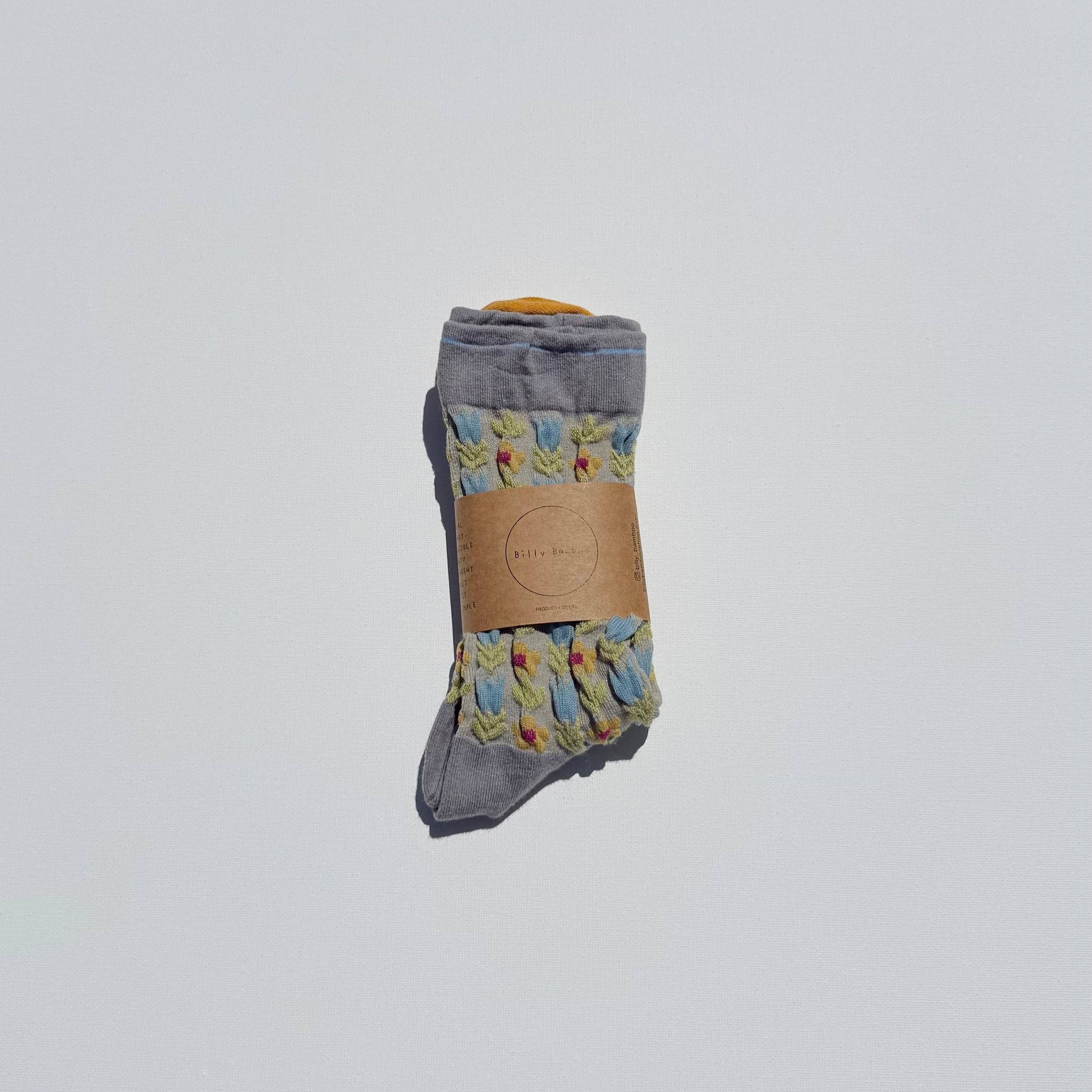 Pair of gray socks with floral patterns on a white background