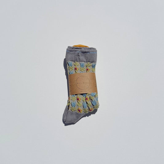Pair of gray socks with floral patterns on a white background